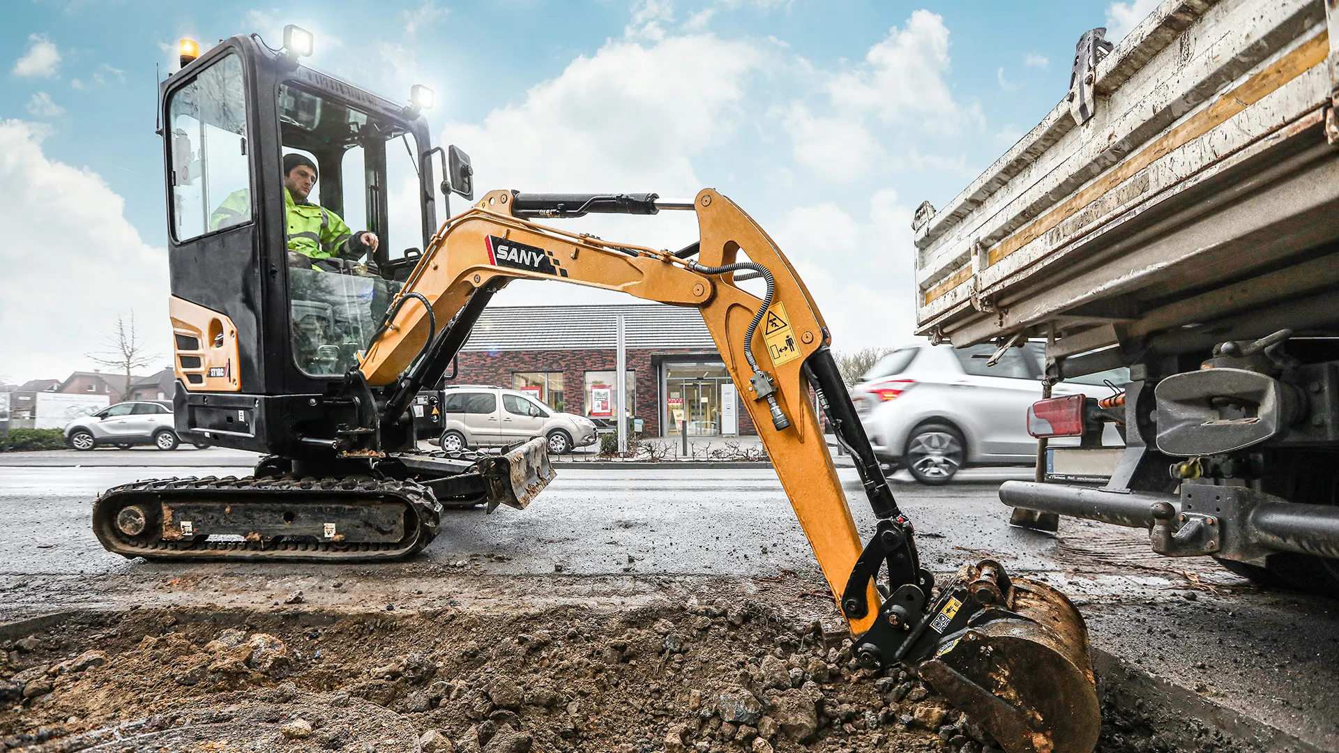 Mini excavator digging in an urban worksite